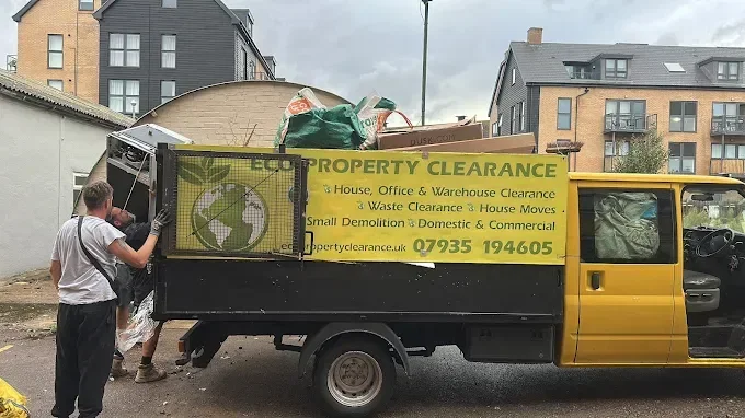 Eco Property Clearance team loading a branded tipper truck with clearance waste