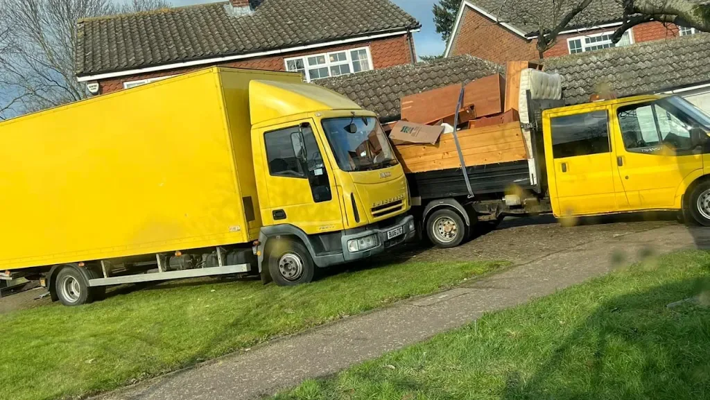 Eco Property Clearance box lorry and tipper truck loaded with clearance items on a residential street